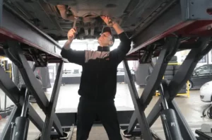 mechanic working under a lifted car