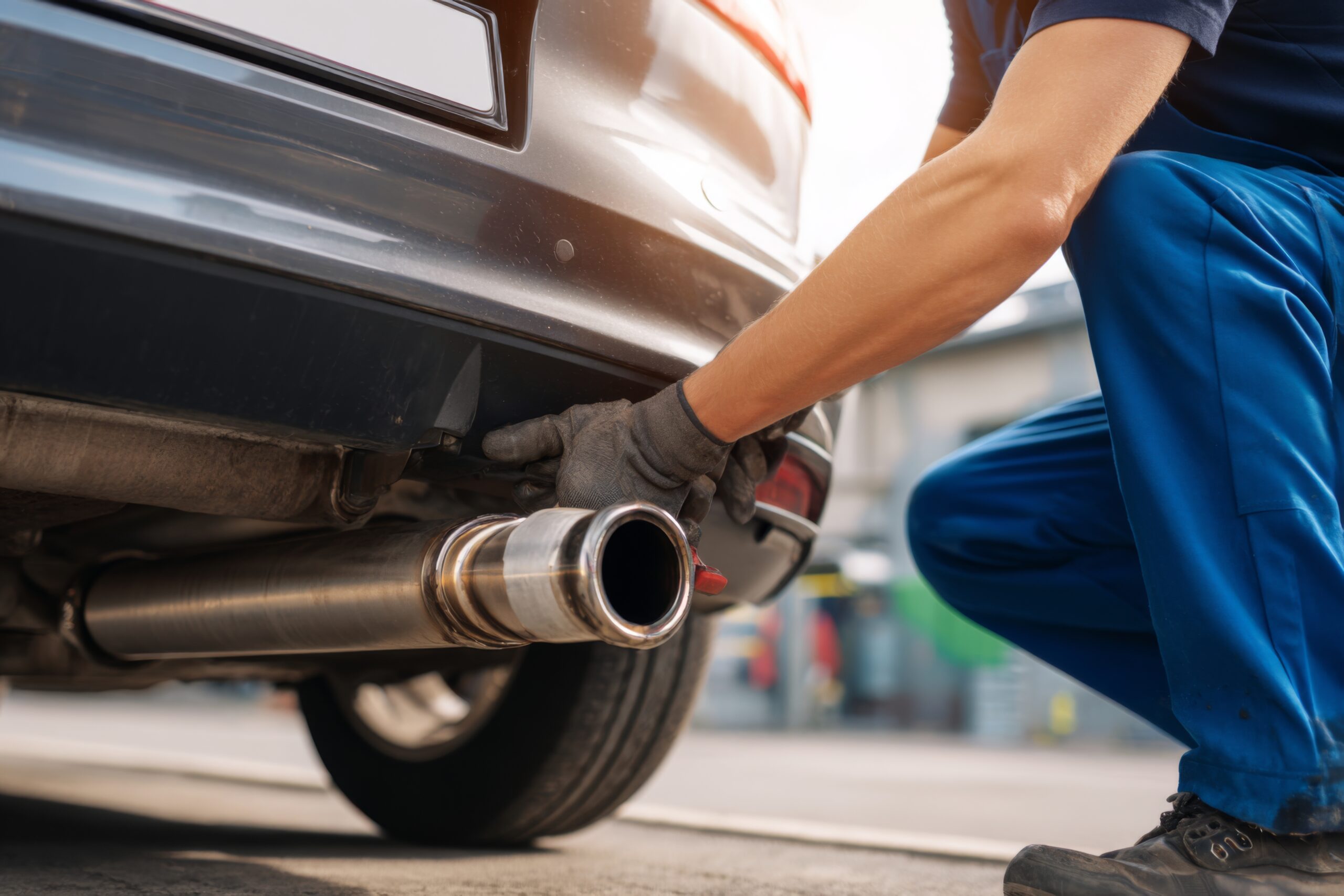 mechanic works on a car